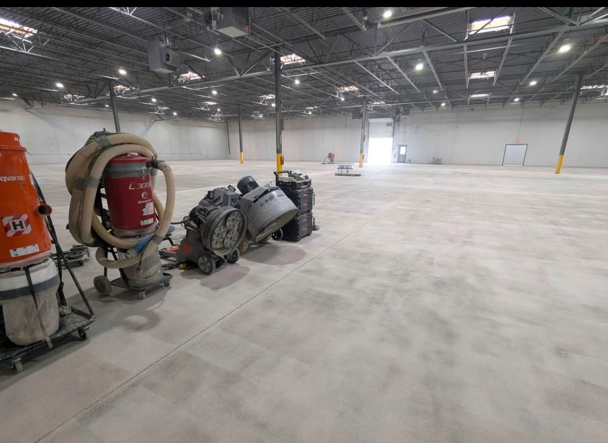 Crew grinding a warehouse slab