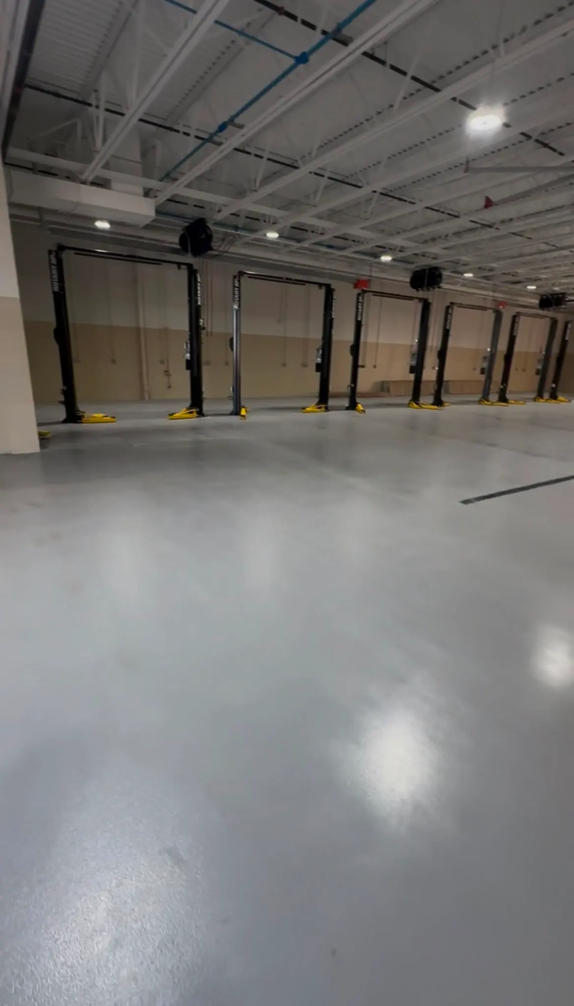 Gray service floor with lift bays along the wall