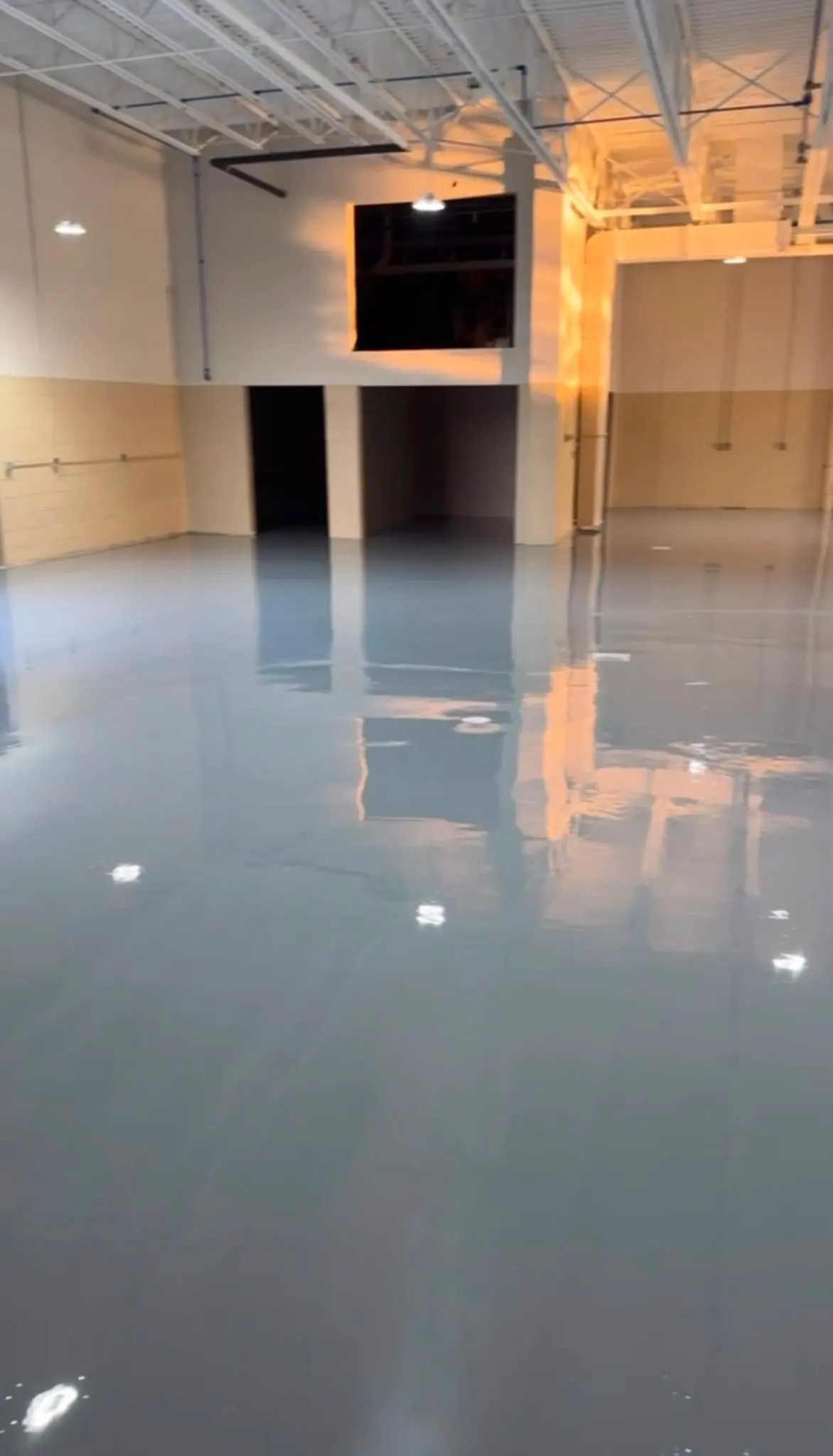 Solid color epoxy floor detail at a wall junction